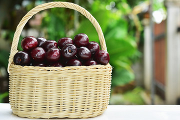 Cherry in basket ,sweet and juicy organic cherries  with green background. 
