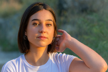 Close up of a woman with short hair looking at the camera.