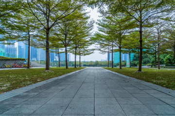 Empty square floor and green forest natural scenery in the city park