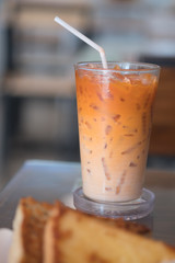Thai milk tea in glass with straw
