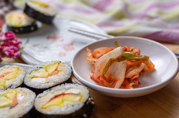 Kimchi and Gimbap serving on white plate