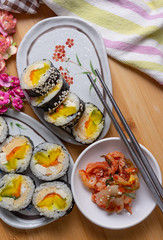 Kimchi and Gimbap serving on white plate