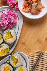 Kimchi and Gimbap serving on white plate