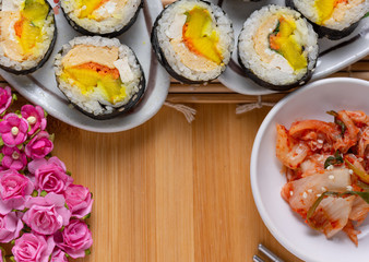 Kimchi and Gimbap serving on white plate