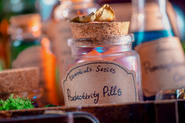 Potions, mixtures, and remedies for inspiration, motivation and productive work close-up. Handwritten potion label. Self-care concept.