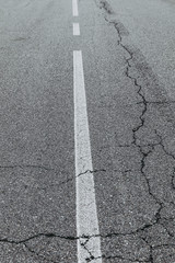 street signs cracked road with white painted signs, traffic signs 