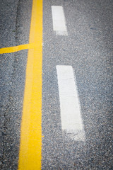 Fototapeta premium white and yellow road marking on street