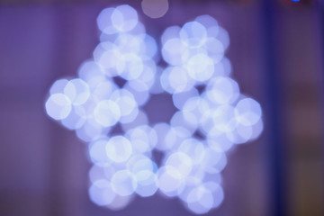 Abstract texture with light blurred blurred snowflake and black background