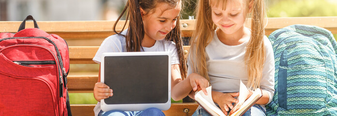 Back to school. Happy children ready for primary school. Pupil on first day of classes. girl with backpack and book on backyard. Education for kindergarten and preschool kids.