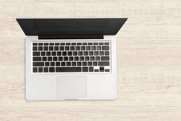 Fototapeta na wymiar Laptop computer on white wooden background.