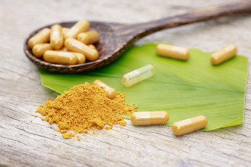 Herbal medicine in capsules from turmeric herb for healthy eating 