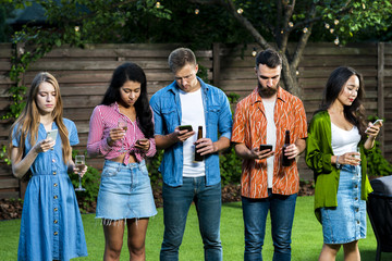 Young people outdoors with phones texting