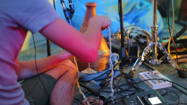 musician playing on musical instrument finger cymbals at a concert