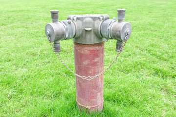Fire hydrant against a green lawn,  Fire hydrant sits in a grass field.