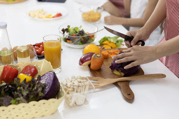 Close up hand of women make a cooking She is cutting salad, vegetable in the kitchen at home. Healthy food concept