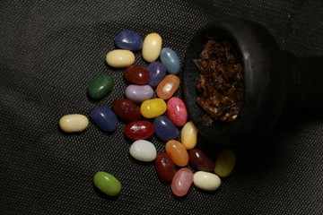 bowl with tobacco for hookah. berries on a black background