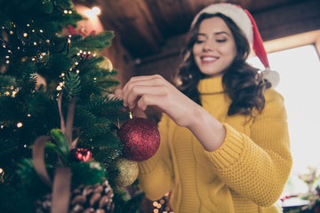 Low below angle view photo of nice charming fascinating girlfriend wearing yellow jumper decorating her christmas fur tree while wearing yellow jumper