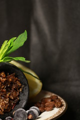 bowl with tobacco for hookah. berries on a black background