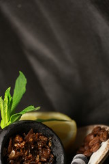 bowl with tobacco for hookah. fruits on a black background. smoking hookah