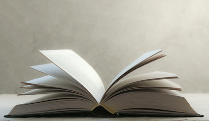 Open book on a gray background .Close-up. Copy space.