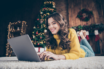 Photo of cute nice charming attractive girl woring in eve of new year with her laptop wearing jeans...
