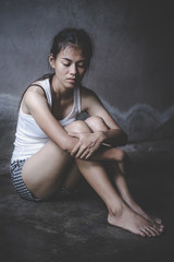 Fototapeta premium Women sitting on the floor with depression, family problems, Domestic violence, Stop violence and abuse ,sexual abuse, human trafficking, rape, The concept of depression and suicide,