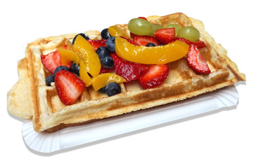 Waffle with fruits - strawberries, blueberries, peaches and grapes