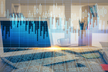 Double exposure of graph and financial info and work space with computer background. Concept of international online trading.