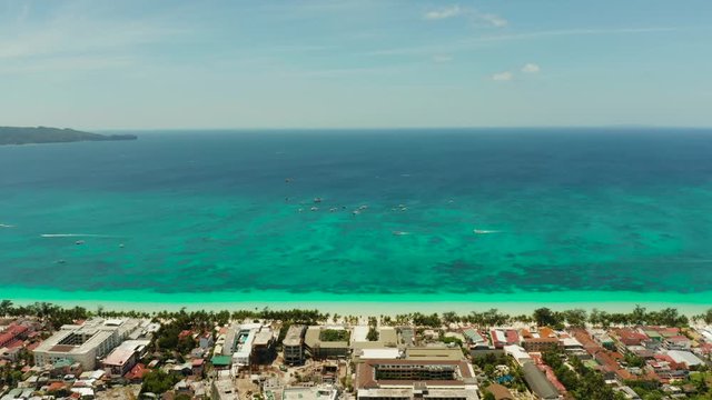 Tropical white sand beach, hotels near the blue lagoon and corall reef. aerial view, Boracay, Philippines. Seascape with beach on tropical island. Summer and travel vacation concept.