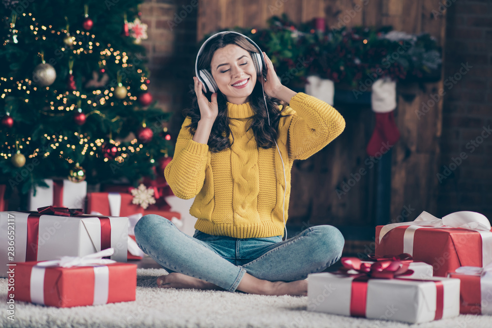 Sticker Full length body size photo of rejoicing nice overjoyed girl listening to christmas music rejoicing with new year atmosphere wearing yellow pullover jeans denim sitting on floor