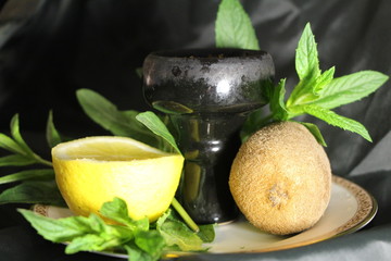 bowl with tobacco for hookah. berries on a black background