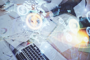 A woman hands writing information about stock market in notepad. Forex chart holograms in front. Concept of research. Double exposure