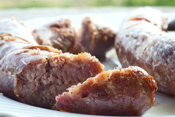 Traditional Istrian (Croatian) sausages with truffle grilled on barbeque and served with fresh farmer's tomato and homemade mustard