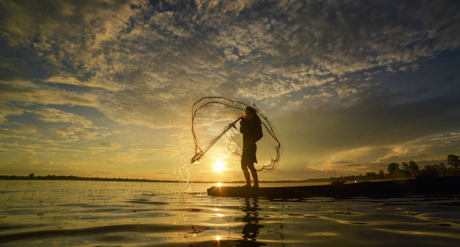 Throwing Fishing Net During Sunrise, Thailand Stock Photo, Picture and  Royalty Free Image. Image 12916525.