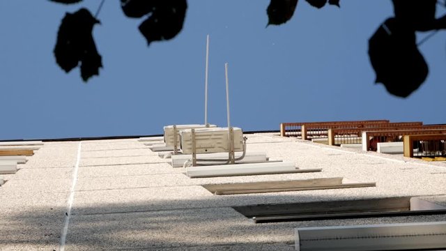 Water dripping from air conditioner at the wall of an apartment seen from below, slow motion