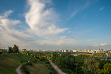 Fototapeta na wymiar View of the city of Kiev, the Dnieper River. City panorama with a place across the river, park, summer day.