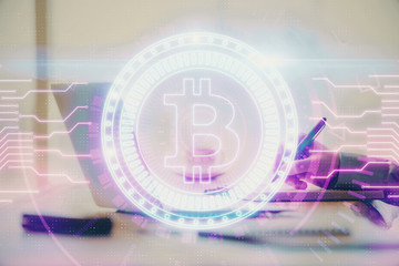 Blockchain theme hologram with man working on computer on background. Concept of crypto chain. Double exposure.