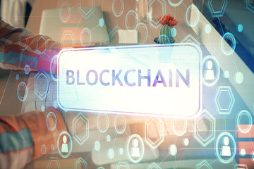 Blockchain theme hud with man working on computer on background. Concept of crypto chain. Double...