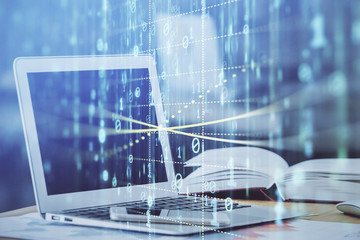 Double exposure of table with computer on background and data theme hologram. Data technology...