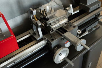 Part of a lathe with handles for longitudinal and transverse feed. Close-up. Metalworking equipment. Industrial equipment. Concept Metal Manufacturing.