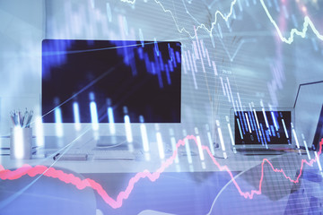 Forex graph hologram on table with computer background. Multi exposure. Concept of financial markets.