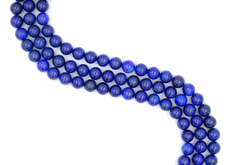 Blue lapis lazuli natural stone round shape bead isolated on white background