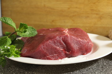 raw beef steak with herbs