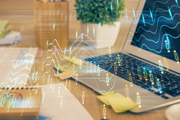Multi exposure of chart and financial info and work space with computer background. Concept of...