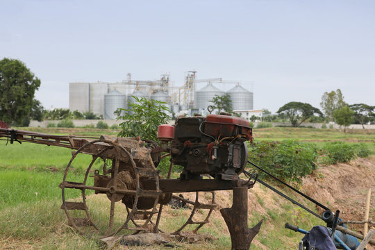 Old two-wheeled tractors are used in water pumping. Close up machine for lowing field, tractor
