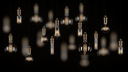 Fototapeta na wymiar Decorative vintage light bulbs in Edison style on a black background. 3D rendering.