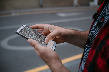 Male hands with the phone, navigation. Close-up.