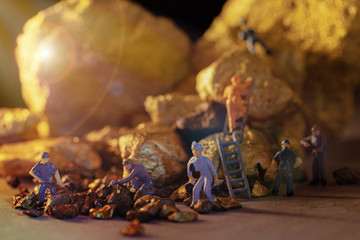 macro miner figures working on group of Bitcoin mining in deep golden cave