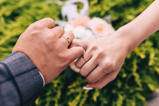 Picture of man and woman with wedding ring.Young married couple holding hands, ceremony wedding day. Newly wed couple's hands with wedding rings