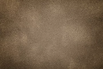 Fotobehang Background of light bronze suede fabric closeup. Velvet matt texture of brown nubuck textile © nikol85